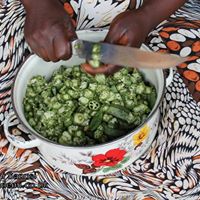 Nigerian woman chopping okra